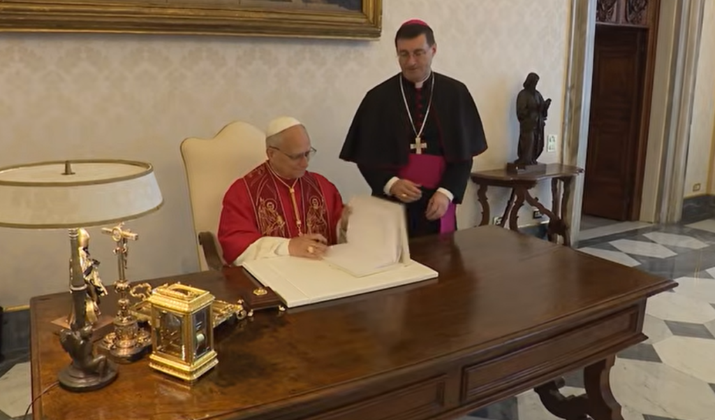 Pope Leo XIV signing the Magnifica humanitas